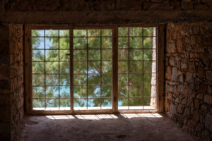 View through a barred window on pine trees, Spinalonga, (former leprosy island), Greece, Crete, Kalydon View through a barred window on pine trees, Spinalonga, (former leprosy island), Greece, Crete, Kalydon