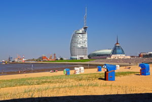 Beach with beach chairs on the banks of the Weser with Sail City Hotel, Low-energy house and Mediterraneo, Bremerhaven, Weser mouth, Land Bremen, Northern Germany, Germany Beach with beach chairs on the banks of the Weser with Sail City Hotel, Low-energy house and Mediterraneo, Bremerhaven, Weser mouth, Land Bremen, Northern Germany, Germany