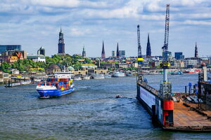 Small container ship on the Elbe in the harbor with the city skyline, Hamburg, Elbe, Land Hamburg, Germany