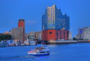Harbor tourboat with the Elbphilharmonie on the Elbe island Grasbrook in the Hafencity at the harbor, Hamburg, Hamburg State, Germany, dusk