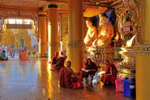 Monks in front of one of the altars in the temples of Shwedagon Pagoda, Yangon, Myanmar Monks in front of one of the altars in the temples of Shwedagon Pagoda, Yangon, Myanmar