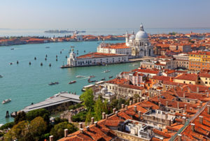 View over the old town roofs of the lagoon with the Punta Dogana and the church Santa Maria della Salute, Venice, Veneto, Italy, UNESCO World Heritage Site View over the old town roofs of the lagoon with the Punta Dogana and the church Santa Maria della Salute, Venice, Veneto, Italy, UNESCO World Heritage Site