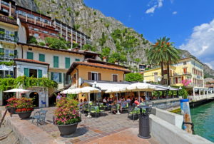 Restaurant terrace on the lakeshore in the center, Limone sul Garda, Lake Garda, Lombardy, Northern Italy, Italy