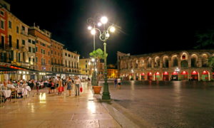 Street cafes and restaurants at Piazza Bra with the Arena di Verona, Verona, Veneto, northern Italy, Italy, evening