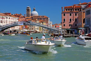 Grand Canal with water taxis, the Ponte degli Scalzi bridge and the church San Geremia, Venice, Veneto, Italy, UNESCO World Heritage Site