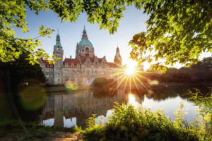New town hall in Hanover at sunrise surrounded by greenery New town hall in Hanover at sunrise surrounded by greenery