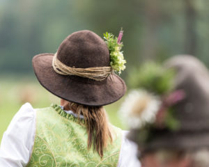 Viehscheid' after the cattle drove down from the mountain pastures in late summer in Bavaria, farmer's wife with felt hat and flower decoration, back view Viehscheid' after the cattle drove down from the mountain pastures in late summer in Bavaria, farmer's wife with felt hat and flower decoration, back view