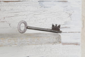 old key on white vintage wood, close-up old key on white vintage wood, close-up