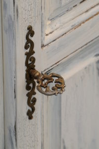 Furniture fitting in old brass, artfully ornated, antique key Furniture fitting in old brass, artfully ornated, antique key