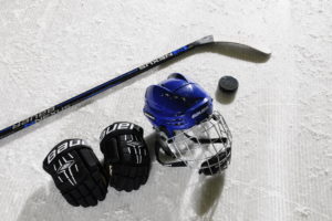 Ice hockey stick and helmet on ice surface Ice hockey stick and helmet on ice surface