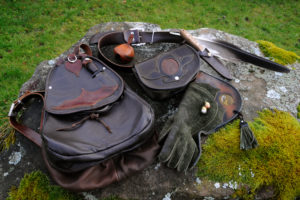 Falconer's equipment on a moss-covered stone arranges Falconer's equipment on a moss-covered stone arranges