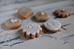 Cookies with heart and Love writing in close-up on white shabby chic background Cookies with heart and Love writing in close-up on white shabby chic background