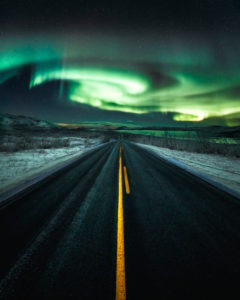 Norldichter across a long straight road near Kilpisjärvi, Lapland, Finland Norldichter across a long straight road near Kilpisjärvi, Lapland, Finland