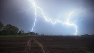 A double lightning strike near Wietmarschen / Nordhorn with a field in the foreground A double lightning strike near Wietmarschen / Nordhorn with a field in the foreground