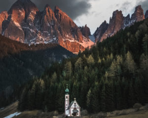 The church of Santa Maddalena in Val di Funes (Vilnößtal) with the Geisler group in the background in the sunset The church of Santa Maddalena in Val di Funes (Vilnößtal) with the Geisler group in the background in the sunset