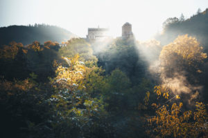 Autumn sunrise over an old castle with sunbeams in the Hunsrück Autumn sunrise over an old castle with sunbeams in the Hunsrück