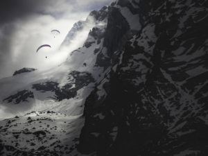 Paraglider pilots on the Watzmann near Berchtesgaden in the clouds and with snow. Dramatic mood Paraglider pilots on the Watzmann near Berchtesgaden in the clouds and with snow. Dramatic mood