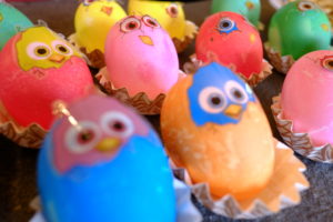 Colored Easter eggs with stickers looking like freshly hatched chickens Colored Easter eggs with stickers looking like freshly hatched chickens