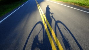 Cyclist's shadow projected or road, Lake Hill, NY Cyclist's shadow projected or road, Lake Hill, NY