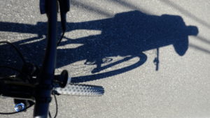 Cyclist's shadow projected or road, Lake Hill, NY Cyclist's shadow projected or road, Lake Hill, NY