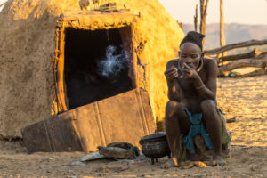 Himba man in front of the mud hut Himba man in front of the mud hut