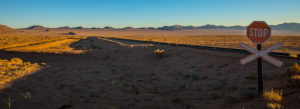 Road to Lüderitz with a stop sign Road to Lüderitz with a stop sign