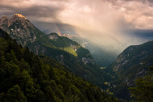 View into the valley of Trenta in majestic evening light with rainbow, Kanjavec summit, Mali Spicje, Velika Ticharica, Triglav National Park, Slovenia View into the valley of Trenta in majestic evening light with rainbow, Kanjavec summit, Mali Spicje, Velika Ticharica, Triglav National Park, Slovenia