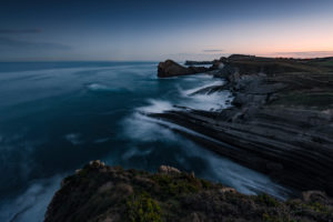 Playa Romantica near Liencres in Cantabria / Spain, twilight before sunrise, bathed in blue light,