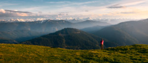 Hiker in front of breathtaking Alpine scenery in the Austrian Alps at Bischofsmütze mountain