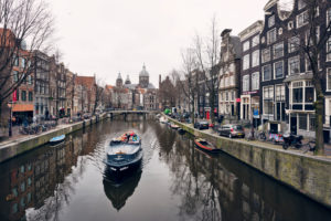 Scene from Amsterdam with canal, boat and typical houses