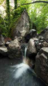 Small waterfall in the forest in the French Alps in summertime