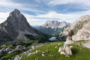 Hiker overlooking the Seebensee with Zugspitze and Sonnenspitze,Wetterstein Mountains,Alps,Tyrol,Austria,Europe