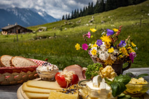 Quaint mountain pasture in the Alps, snack on the terrace, Berchtesgadener Land, Bavaria, Germany Quaint mountain pasture in the Alps, snack on the terrace, Berchtesgadener Land, Bavaria, Germany