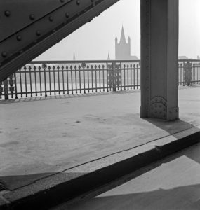 The filigree balustrade at the Hindenburg bridge over river Rhine from Deutz to Cologne city with view to St. Martin's church, Germany 1930s. The filigree balustrade at the Hindenburg bridge over river Rhine from Deutz to Cologne city with view to St. Martin's church, Germany 1930s.
