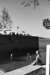 Two young women and a young man sunbathing and swimming in the Chiemsee, Dermany 1930s. Two young women and a young man sunbathing and swimming in the Chiemsee, Dermany 1930s.