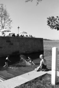 Two young women and a young man sunbathing and swimming in the Chiemsee, Dermany 1930s. Two young women and a young man sunbathing and swimming in the Chiemsee, Dermany 1930s.