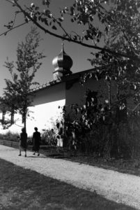Two young women are strolling through the church area at the Chiemsee, Germany 1930s. Two young women are strolling through the church area at the Chiemsee, Germany 1930s.