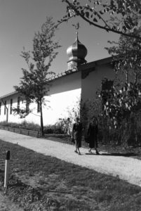 Two young women are strolling through the church area at the Chiemsee, Germany 1930s. Two young women are strolling through the church area at the Chiemsee, Germany 1930s.
