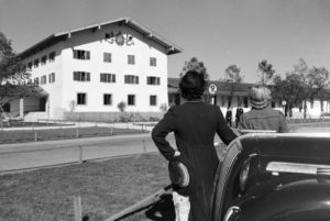 Two young women are looking at the clock on the wall of the city hall at the Chiemsee, Germany 1930s. Two young women are looking at the clock on the wall of the city hall at the Chiemsee, Germany 1930s.