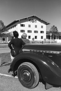 Two young women are looking at the clock on the wall of the city hall at the Chiemsee, Germany 1930s. Two young women are looking at the clock on the wall of the city hall at the Chiemsee, Germany 1930s.