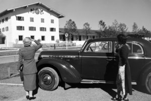 Two young women are looking at the clock on the wall of the city hall at the Chiemsee, Germany 1930s. Two young women are looking at the clock on the wall of the city hall at the Chiemsee, Germany 1930s.