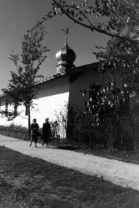 Two young women are strolling through the church area at the Chiemsee, Germany 1930s. Two young women are strolling through the church area at the Chiemsee, Germany 1930s.