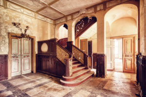 entrance hall with stairway in an abandoned castle entrance hall with stairway in an abandoned castle