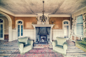 Living room in an abandoned villa with chimney and two armchairs Living room in an abandoned villa with chimney and two armchairs