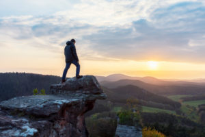 Hiker, young man, stands on vantage point, castle Drachenfels, Palatinate Forest, sunset. Hiker, young man, stands on vantage point, castle Drachenfels, Palatinate Forest, sunset.
