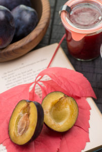 opened book, autumn leaf, plums and stewed plums opened book, autumn leaf, plums and stewed plums