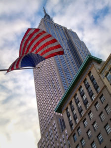 Empire State Building in Manhattan, New York City, USA, In the foreground is an American Flag, Empire State Building in Manhattan, New York City, USA, In the foreground is an American Flag,