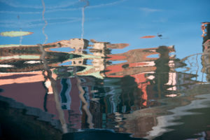 Facades of houses reflected in the water on the island of Burano in the lagoon of Venice, Italy Facades of houses reflected in the water on the island of Burano in the lagoon of Venice, Italy