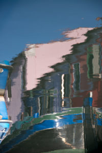 Facades of houses reflected in the water on the island of Burano in the lagoon of Venice, Italy Facades of houses reflected in the water on the island of Burano in the lagoon of Venice, Italy