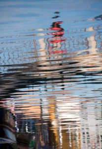 Facades of houses reflected in the water on the island of Burano in the lagoon of Venice, Italy Facades of houses reflected in the water on the island of Burano in the lagoon of Venice, Italy
